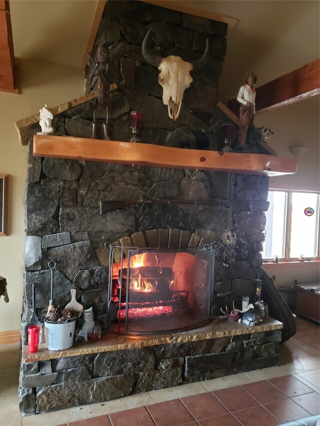 room details with tile flooring and a stone fireplace