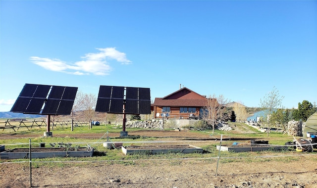 view of front of home featuring a garden and solar panels