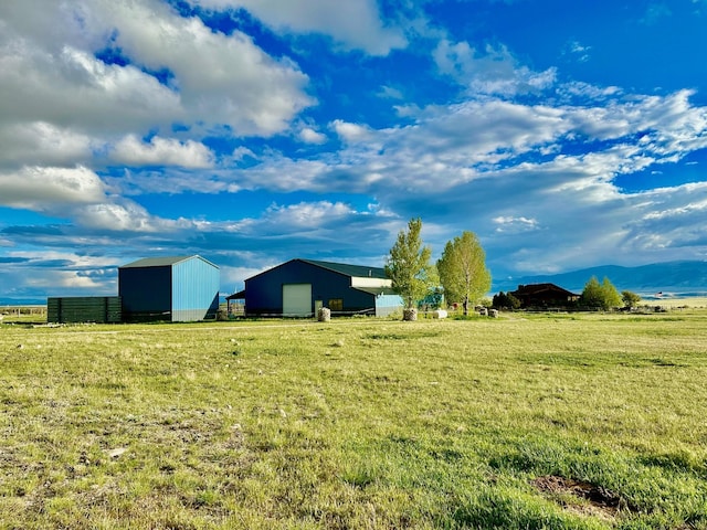 view of yard featuring an outbuilding, an outdoor structure, and a garage