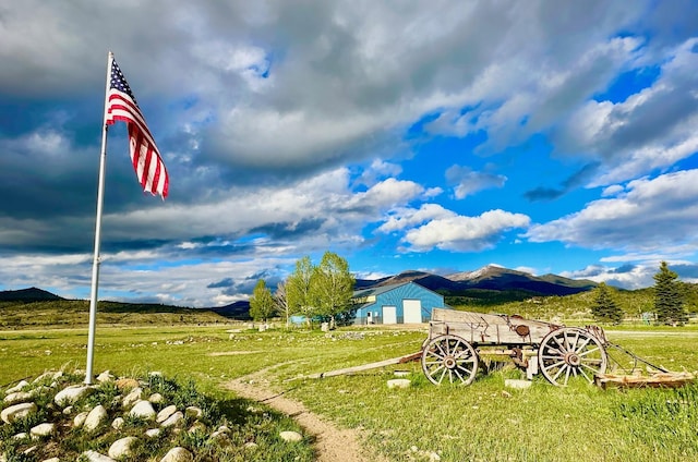 view of yard featuring a rural view and a mountain view