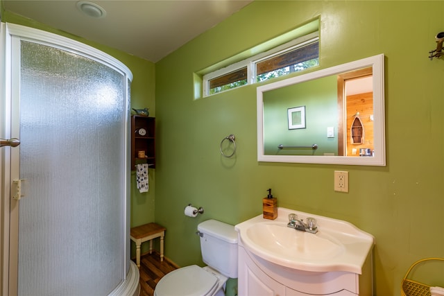 bathroom featuring wood-type flooring, vanity, and toilet