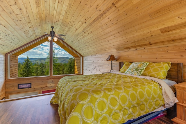 bedroom with vaulted ceiling, wood walls, and wooden ceiling