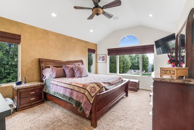 bedroom featuring ceiling fan, vaulted ceiling, and light carpet