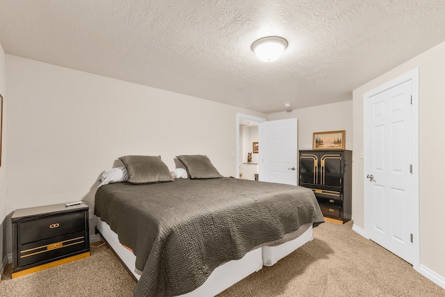 carpeted bedroom with a textured ceiling