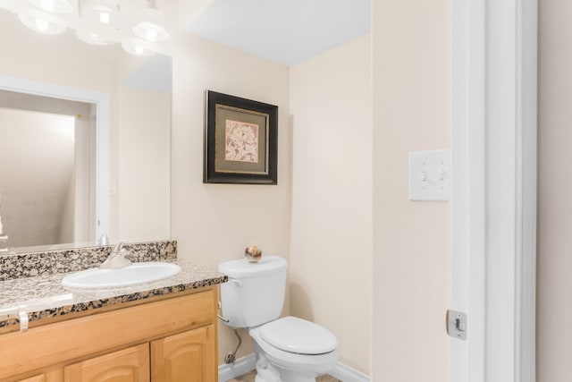 bathroom featuring toilet and vanity