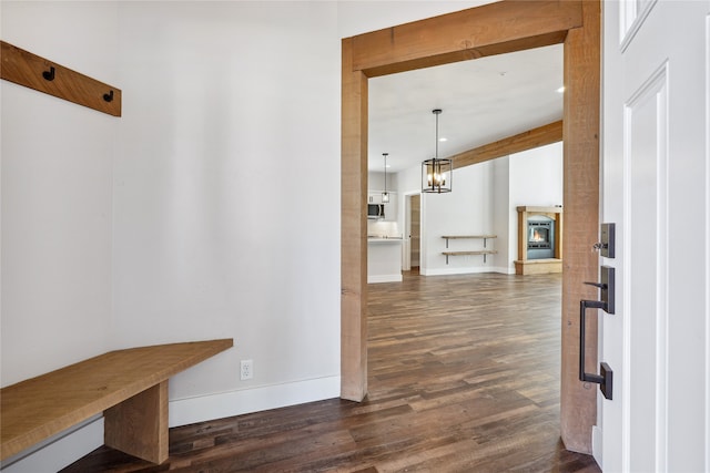 hallway featuring a notable chandelier and dark hardwood / wood-style floors