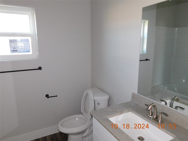 bathroom featuring vanity, toilet, walk in shower, and hardwood / wood-style floors