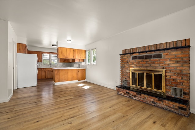 interior space featuring a brick fireplace and wood-type flooring