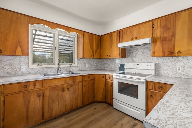 kitchen with white electric stove, tasteful backsplash, sink, and wood-type flooring