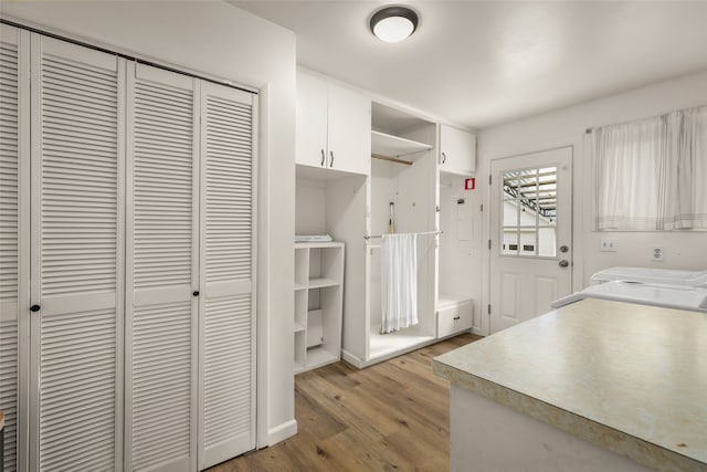 washroom featuring light hardwood / wood-style floors and washer / clothes dryer