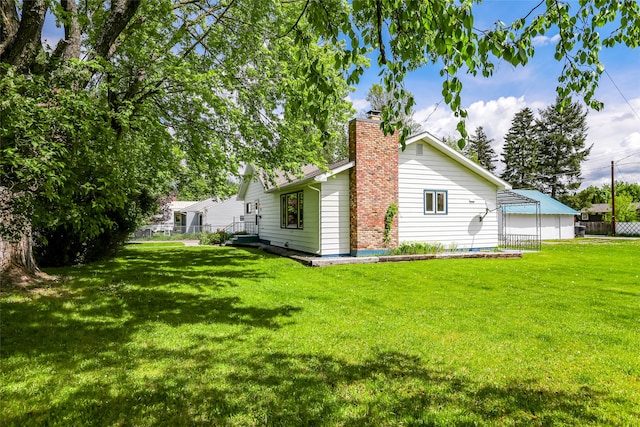 rear view of house featuring a lawn