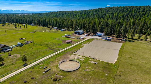 drone / aerial view featuring a rural view and a view of trees