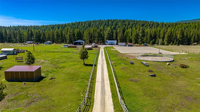 aerial view with a wooded view and a rural view