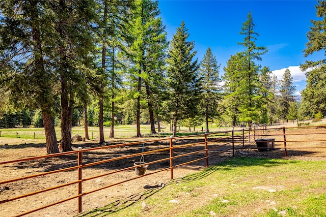 view of yard featuring a rural view and fence