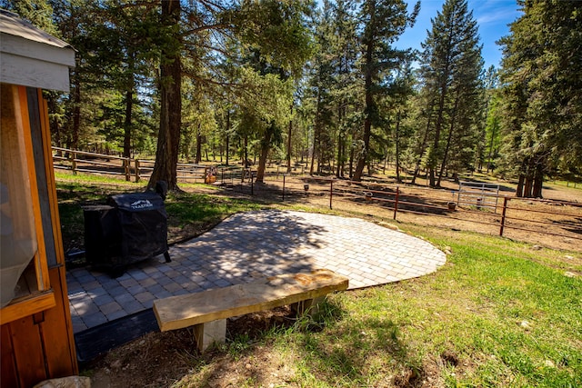 view of yard with fence and a patio