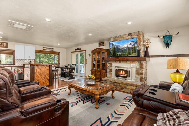 living room with a fireplace and light wood-type flooring