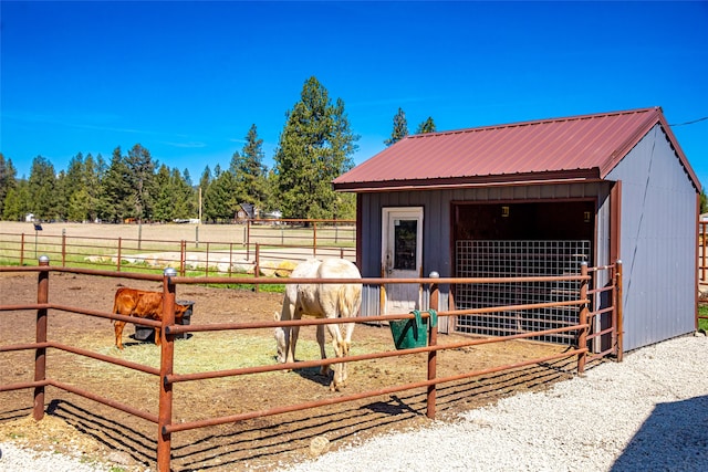 view of stable with a rural view