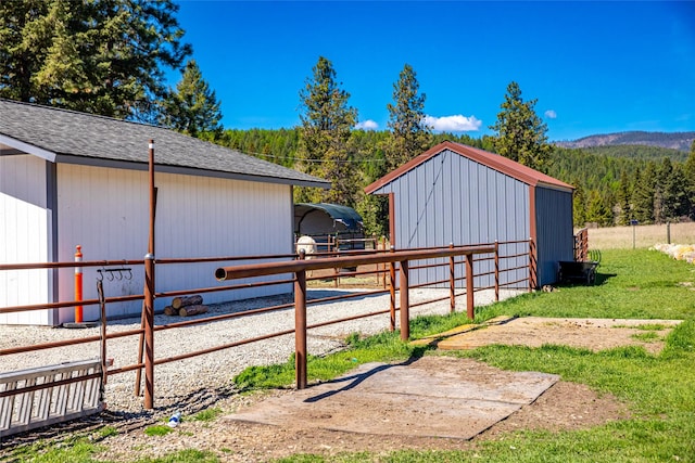 1200 Lost Creek Dr, Kalispell, MT 59901 - view of yard featuring an outbuilding, an exterior structure, a forest view, and a mountain view