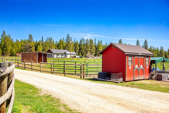 view of stable featuring a rural view