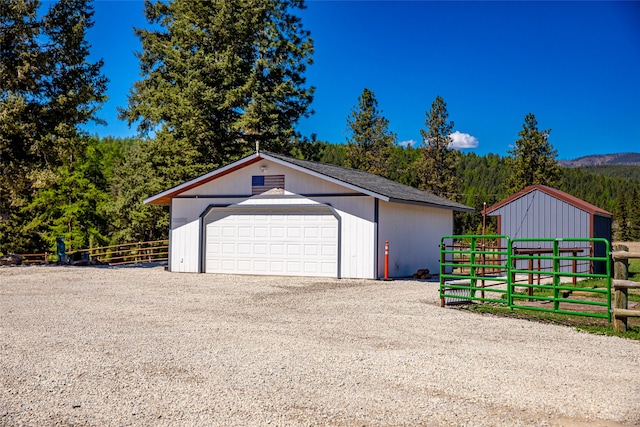 detached garage featuring a wooded view