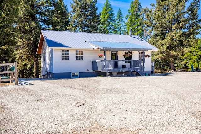 view of front of home featuring metal roof and a porch