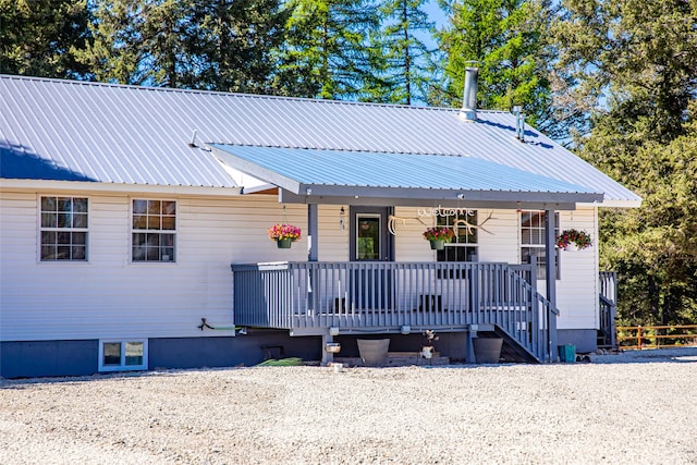 view of front of house with covered porch and metal roof