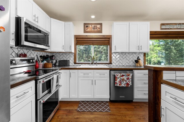 1200 Lost Creek Dr, Kalispell, MT 59901 - kitchen featuring stainless steel appliances, white cabinetry, healthy amount of natural light, recessed lighting, and tasteful backsplash