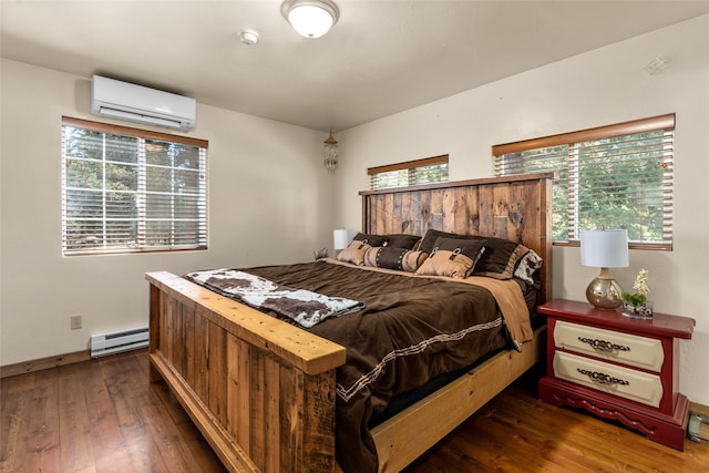 bedroom with baseboard heating, dark hardwood / wood-style floors, and a wall mounted air conditioner