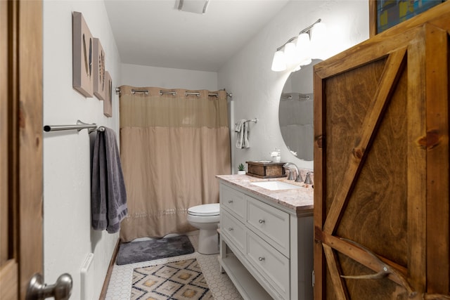 bathroom with tile patterned flooring, a shower with curtain, vanity, and toilet