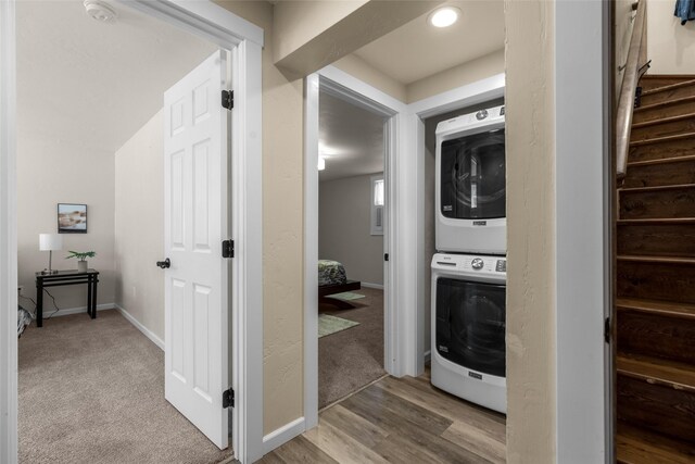 1200 Lost Creek Dr, Kalispell, MT 59901 - washroom with estacked washer and dryer, carpet flooring, and wood finished floors