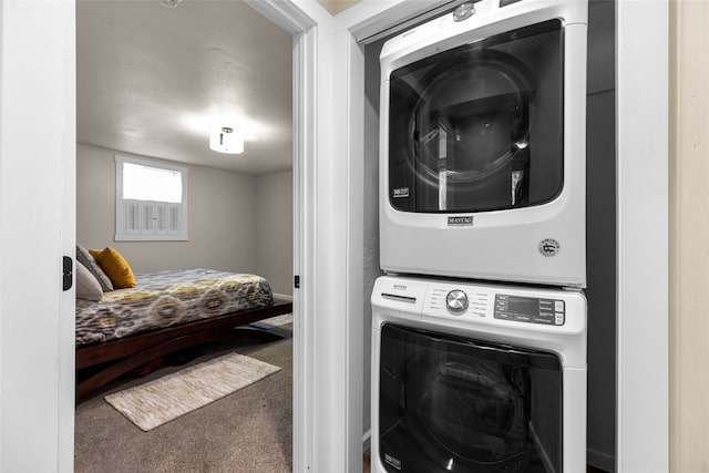 clothes washing area with carpet floors and stacked washing maching and dryer