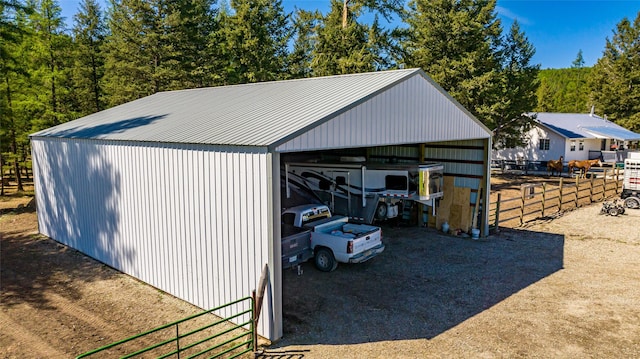 detached garage featuring fence