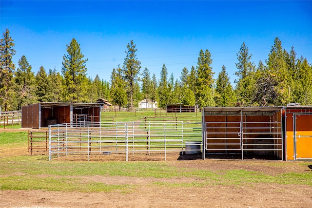 view of yard with an outbuilding and a rural view