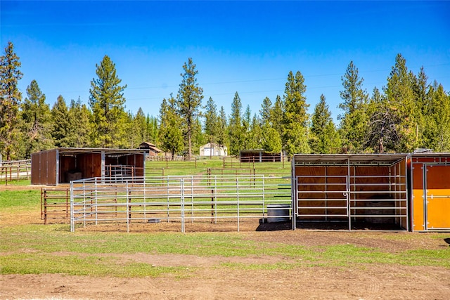 view of horse barn featuring a rural view