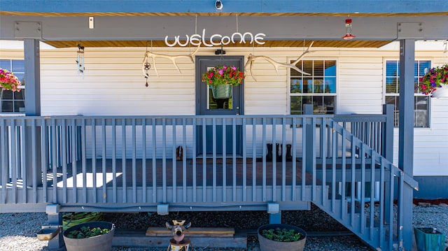 view of exterior entry featuring covered porch