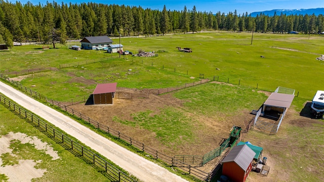 aerial view featuring a wooded view and a rural view