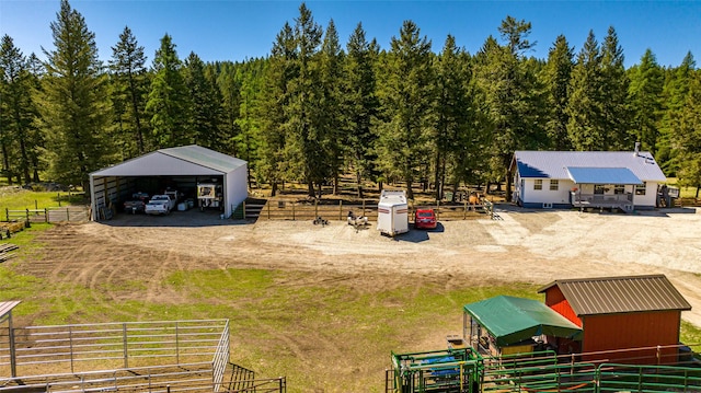 1200 Lost Creek Dr, Kalispell, MT 59901 - view of yard featuring an outdoor structure, a forest view, an outbuilding, and a view of countryside