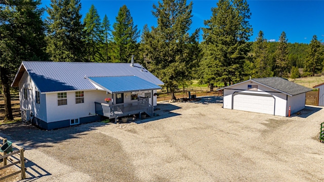 view of front facade with a garage and an outbuilding