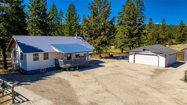1200 Lost Creek Dr, Kalispell, MT 59901 - view of front of house with an outdoor structure, a detached garage, and a metal roof