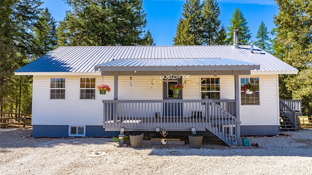 bungalow-style home featuring covered porch and metal roof