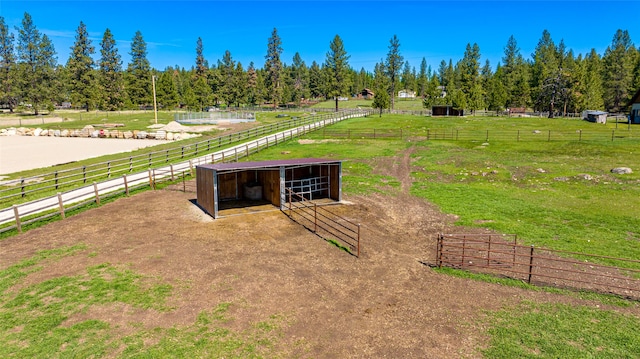 surrounding community featuring a rural view and an outdoor structure