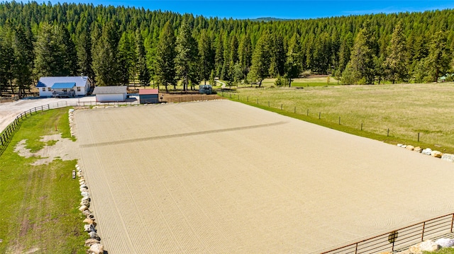 birds eye view of property featuring a wooded view