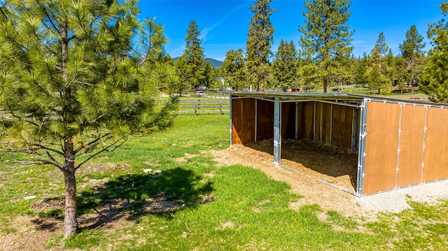 view of outdoor structure featuring an outbuilding and fence