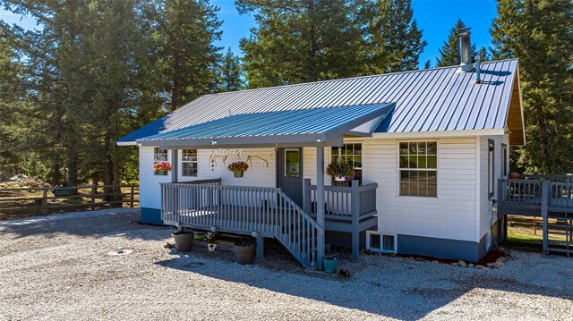 1200 Lost Creek Dr, Kalispell, MT 59901 - view of front of home with fence, covered porch, and metal roof