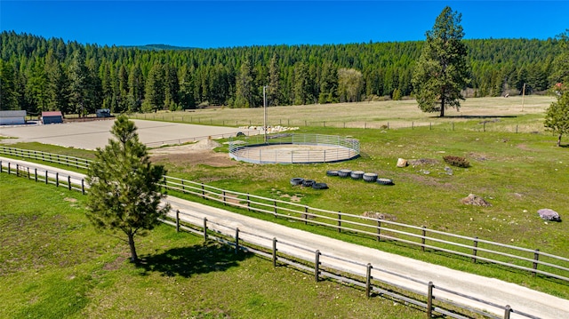 birds eye view of property with a view of trees and a rural view