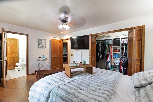 bedroom with hardwood / wood-style flooring, a closet, ensuite bathroom, and ceiling fan