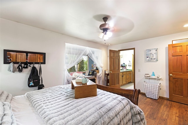 bedroom with ceiling fan, connected bathroom, and hardwood / wood-style flooring