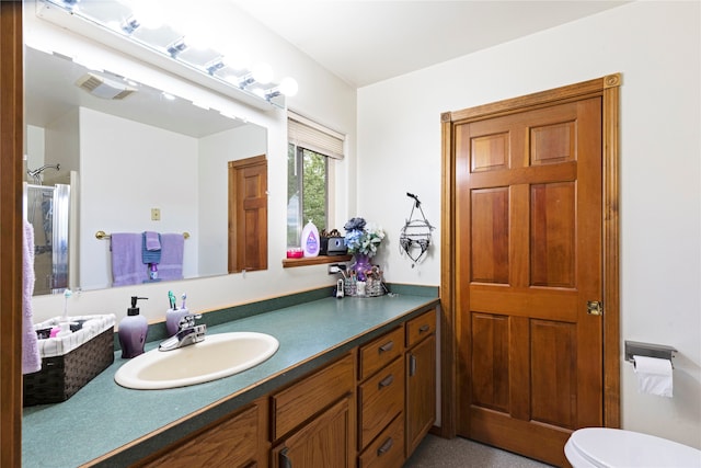 bathroom featuring oversized vanity and toilet