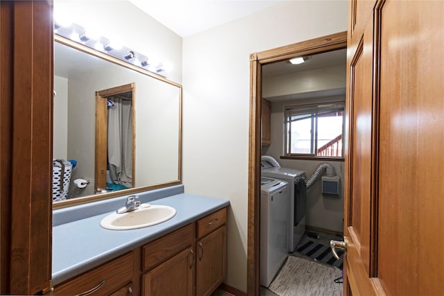 bathroom with washing machine and clothes dryer and vanity