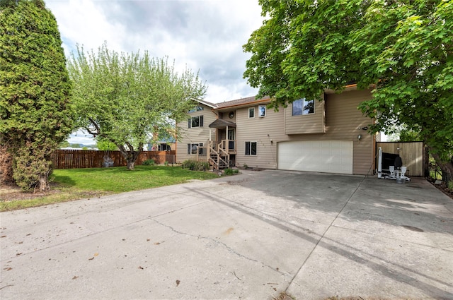 raised ranch with a front yard and a garage